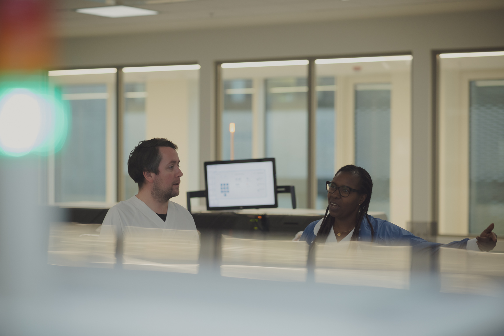 En mann og en kvinne sitter ved et bord og ser på en datamaskin