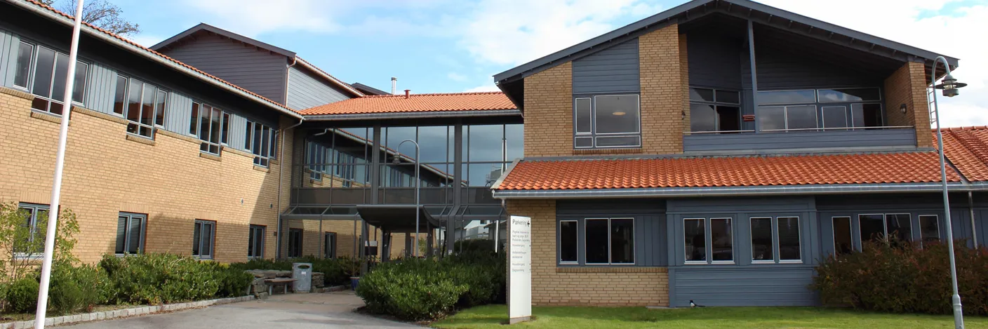 A building with a lawn and a walkway