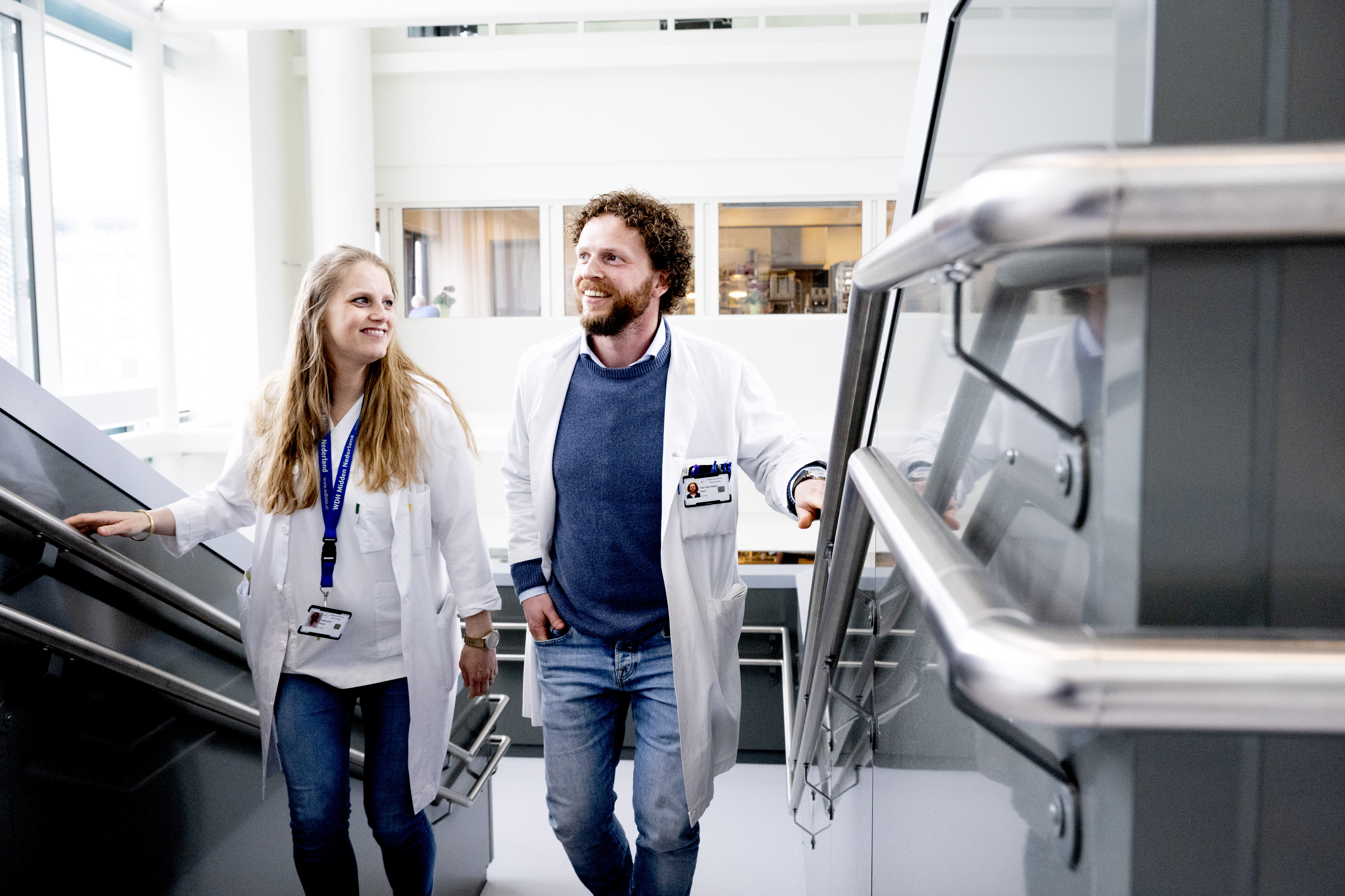 Two doctors on the stairs inside a building