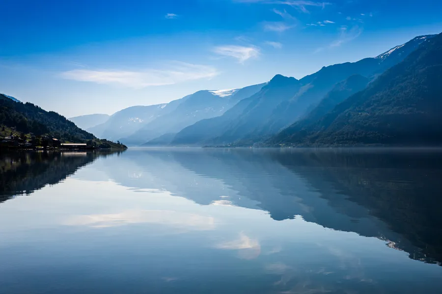 A lake with mountains in the background