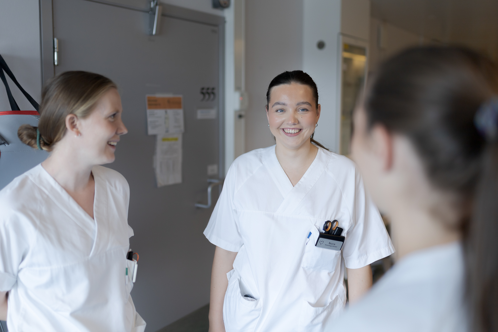 Flere kvinnelige sykepleiere i hvite uniformer