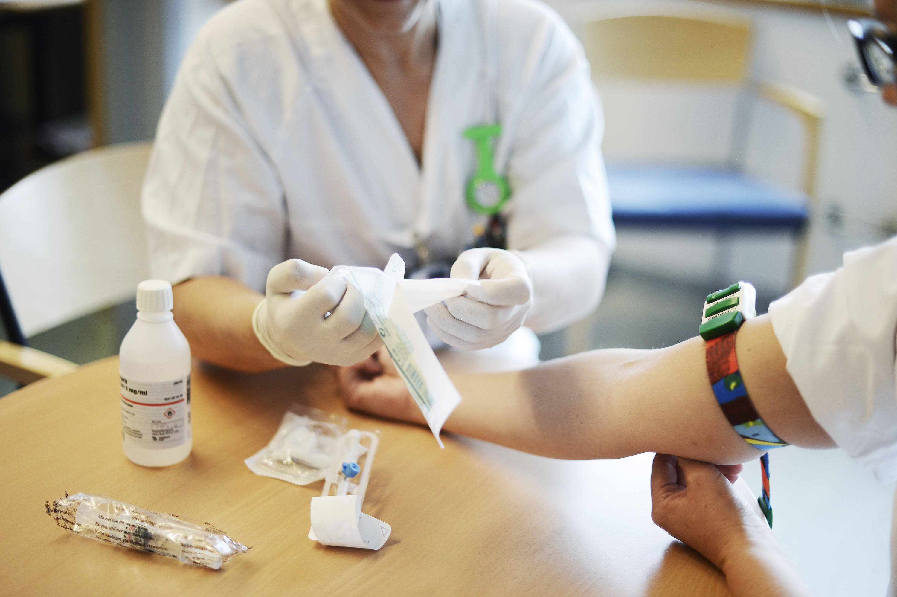 A nurse preparing to take a blood sample from a person