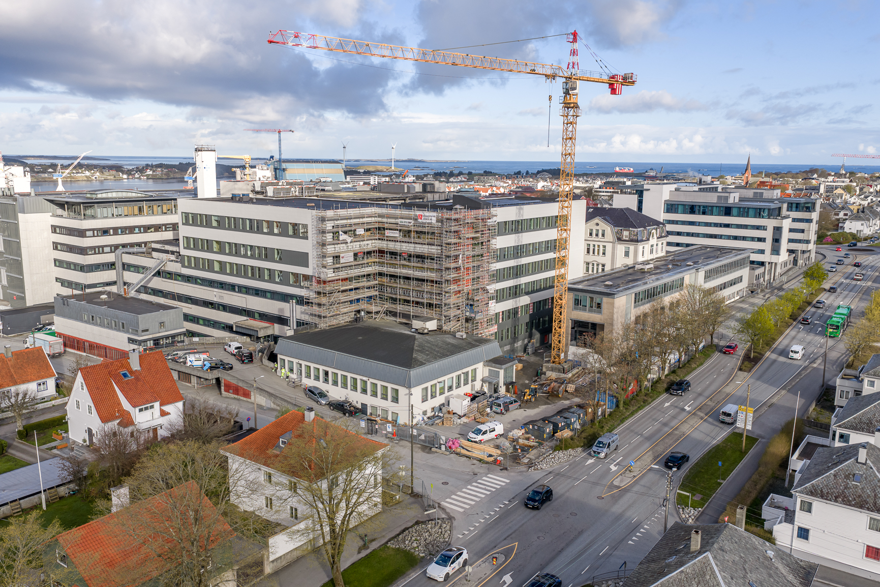 Ein stor bygning med byggekran i ein by