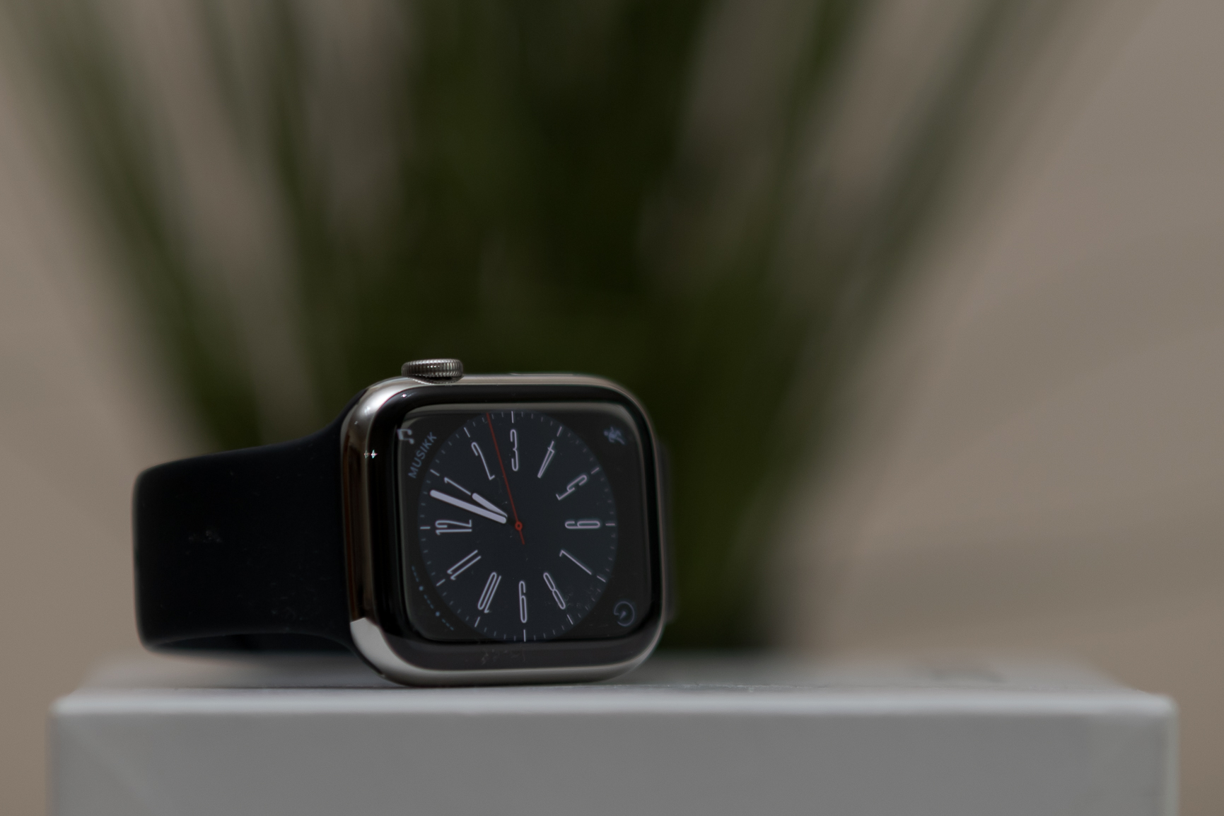 En svart klokke på en hvit overflate