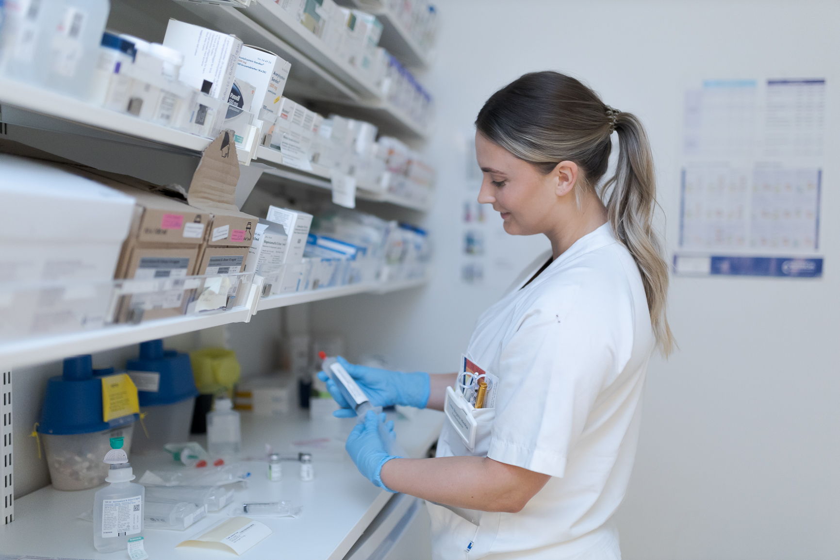 Sykepleier håndterer medisiner på et medisinlager