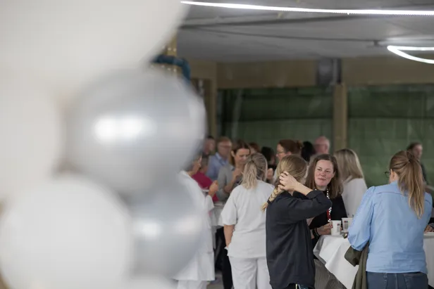 En gruppe mennesker som står i et rom