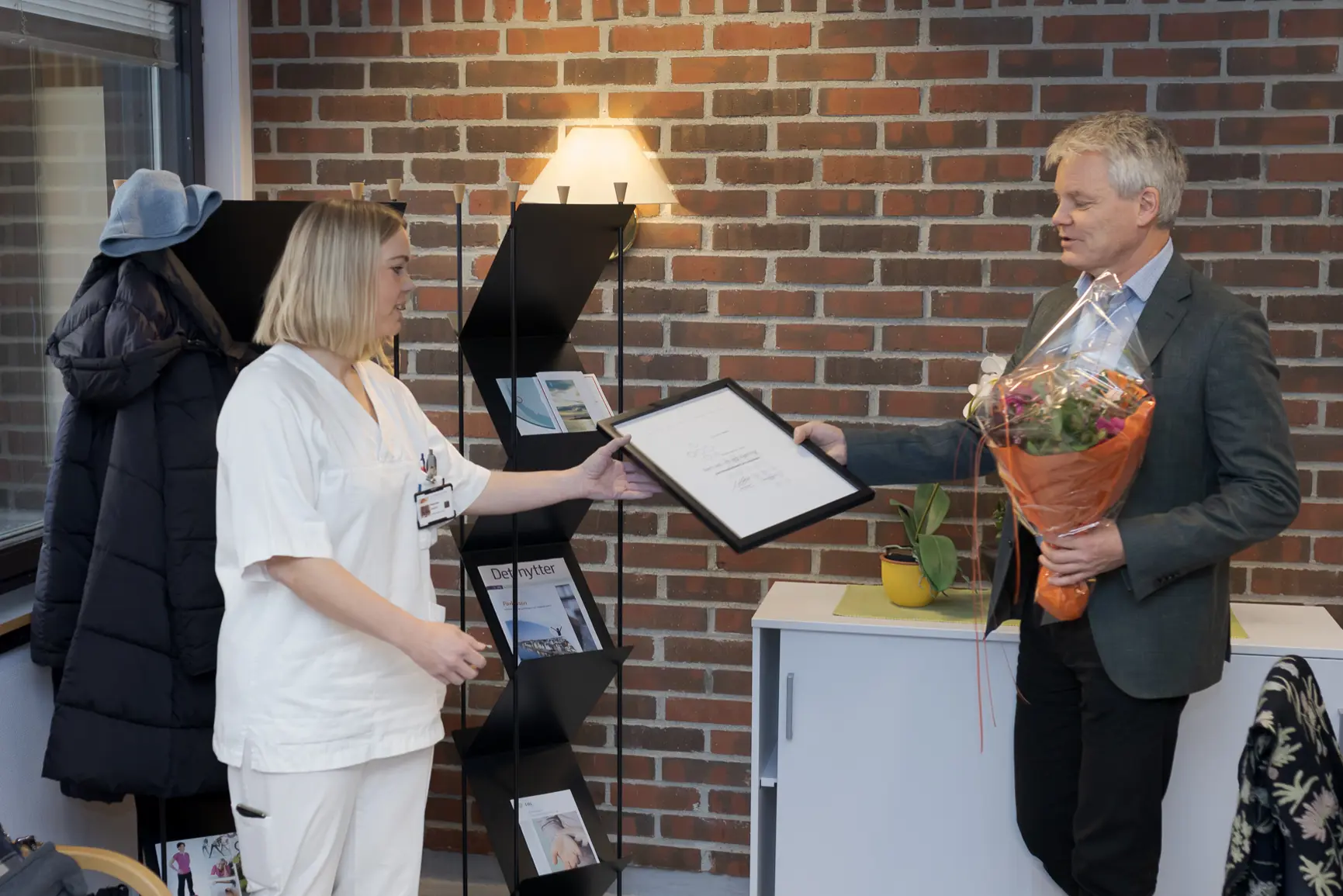 En mann og en kvinne som holder en plakett